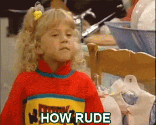 A Little Girl Is Wearing A Red Sweater With The Words How Rude On It GIF