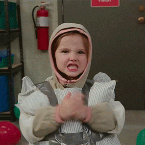 A Little Girl Is Wrapped In Duct Tape And Has A Hood On Her Head GIF