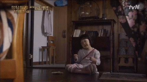 A Little Girl Sits On The Floor In Front Of A Tv Screen GIF