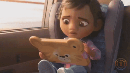 A Little Girl Sitting In A Car Seat Looking At A Tablet GIF