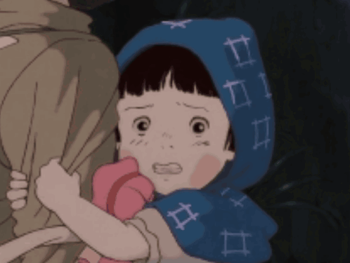 A Little Girl Wearing A Blue Scarf With Numbers On It Is Being Held By A Person GIF