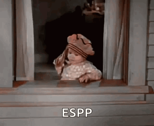A Little Girl Wearing A Hat Is Looking Out Of A Window And Says Espp . GIF