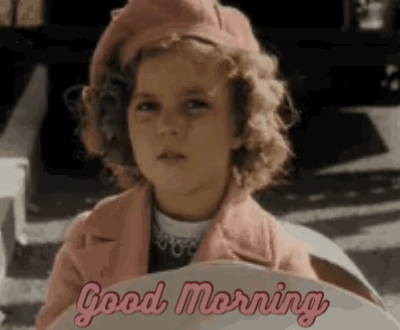 A Little Girl Wearing A Pink Coat And Beret Is Sitting In A Car And Says `` Good Morning '' . GIF