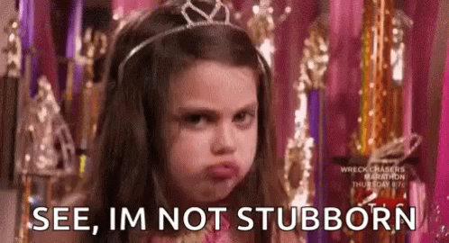 A Little Girl Wearing A Tiara Is Making A Funny Face . GIF