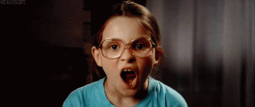 A Little Girl Wearing Glasses Is Making An Angry Face . GIF