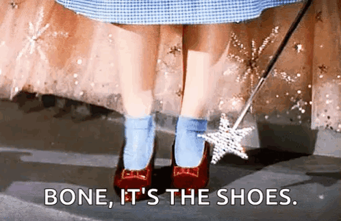 A Little Girl Wearing Red Shoes And Blue Socks Is Holding A Wand And Saying `` Bone , It 'S The Shoes '' GIF