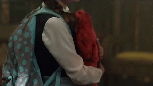 A Little Girl With A Backpack Is Holding A Stuffed Animal GIF