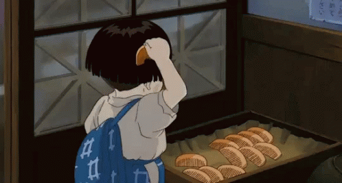 A Little Girl With A Blue Backpack Is Looking At A Tray Of Bread GIF