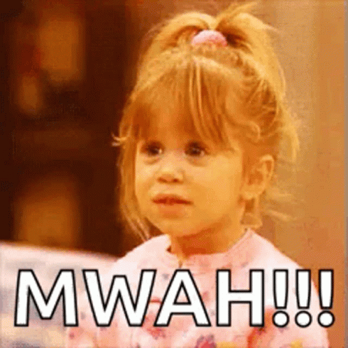 A Little Girl With A Ponytail Is Making A Funny Face And Saying Mwah ! GIF