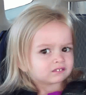 A Little Girl With Blonde Hair Is Sitting In A Car Seat Making A Funny Face . GIF