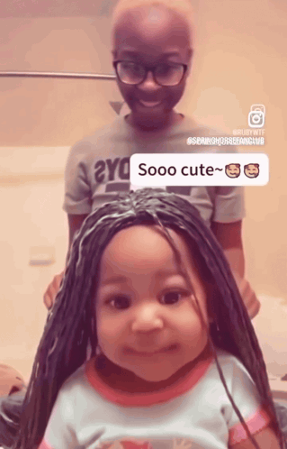 a little girl with braids has a sticker that says sooo cute on her head