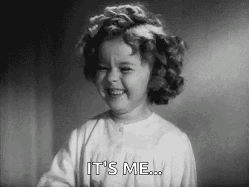 A Little Girl With Curly Hair Is Smiling And Saying `` It 'S Me '' . GIF