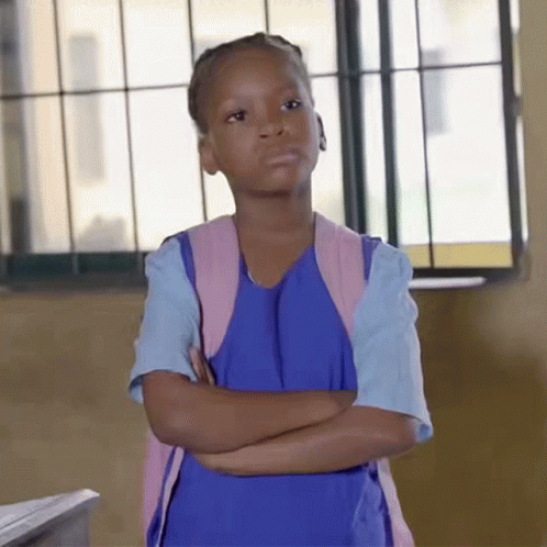 A Little Girl With Her Arms Crossed Wearing A Blue Dress And A Pink Backpack GIF