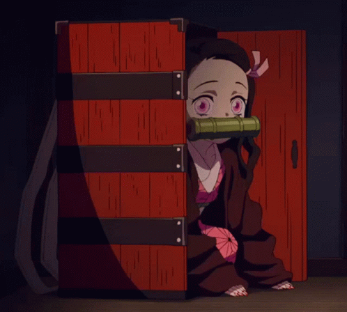 A Little Girl With Pink Eyes Is Sitting In A Red Box GIF