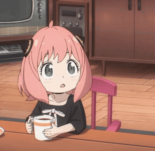 A Little Girl With Pink Hair Is Sitting At A Table With A Cup Of Coffee GIF