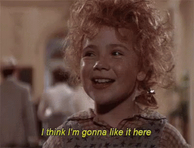 A Little Girl With Red Curly Hair Is Smiling And Saying `` I Think I 'M Gonna Like It Here '' . GIF