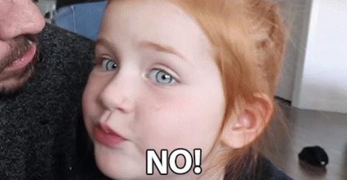 A Little Girl With Red Hair Is Making A Face And Says No GIF