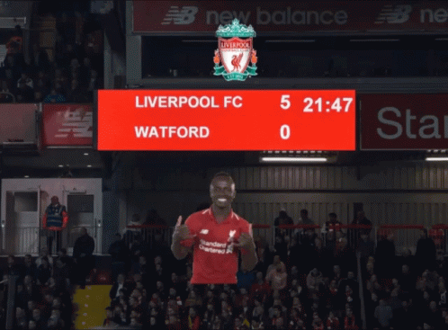A Liverpool Fc Player Giving A Thumbs Up In Front Of A Scoreboard That Says Watford GIF