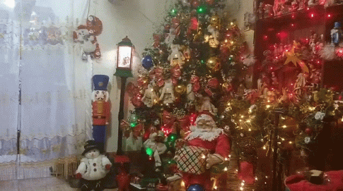 a living room decorated for christmas with a christmas tree and santa claus