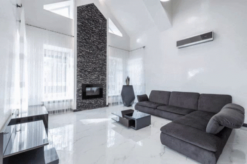 A Living Room With A Black Couch And A Black Coffee Table GIF