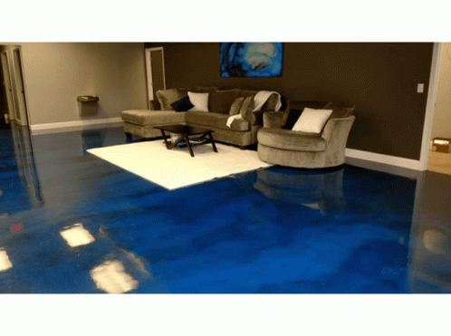 A Living Room With A Blue Floor And Couch GIF