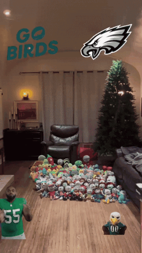 A Living Room With A Christmas Tree And Stuffed Animals And The Words Go Birds On The Ceiling GIF