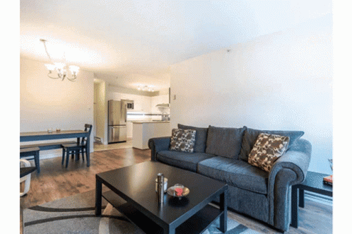 A Living Room With A Couch And A Table GIF