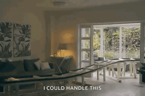 A Living Room With A Couch And A Table And The Words " I Could Handle This " GIF