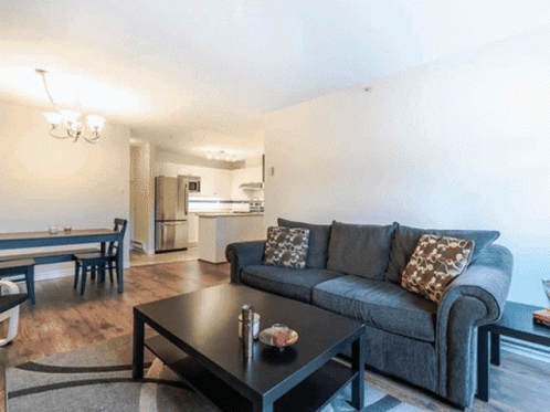 A Living Room With A Couch And A Table GIF