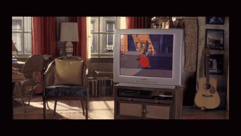 A Living Room With A Philips Tv On The Entertainment Center GIF