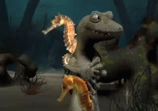 A Lizard Is Holding A Seahorse And Another Seahorse GIF