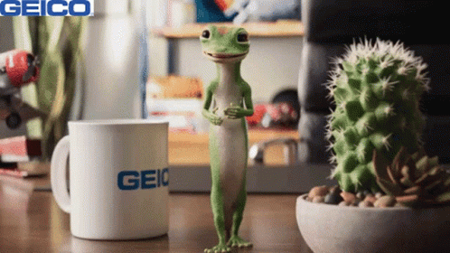 A Lizard Standing Next To A Geico Mug GIF