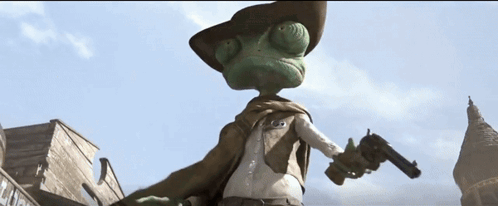 A Lizard Wearing A Cowboy Hat And Cape Stands In Front Of A Building GIF
