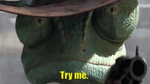 A Lizard Wearing A Cowboy Hat And Pointing A Gun With The Words Try Me Written Below It GIF