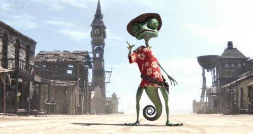 A Lizard Wearing A Hawaiian Shirt And A Cowboy Hat Stands In A Desert Town GIF