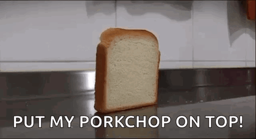 A Loaf Of Bread Is Sitting On A Counter With The Words `` Put My Pork Chop On Top '' . GIF