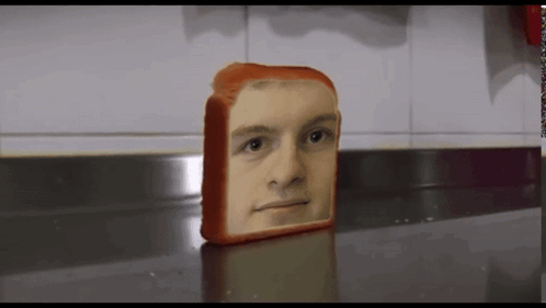 A Loaf Of Bread With A Face On It GIF