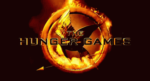 A Logo For The Hunger Games With A Flaming Bird In The Center GIF