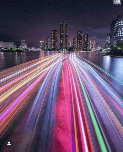 A Long Exposure Photo Of A City At Night With The Word Night On The Bottom GIF