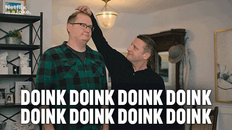 A Man Adjusts Another Man 'S Head With A Caption That Says Doink Doink Doink Doink Doink Doink Doink GIF