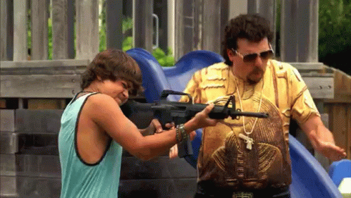 A Man And A Boy Are Playing With A Gun At A Playground GIF