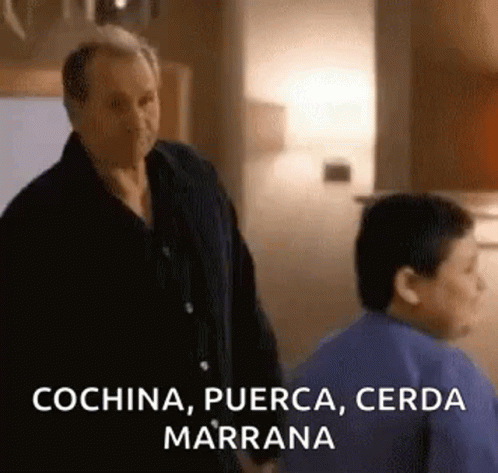 A Man And A Boy Are Standing Next To Each Other In A Kitchen And The Man Is Talking To The Boy . GIF