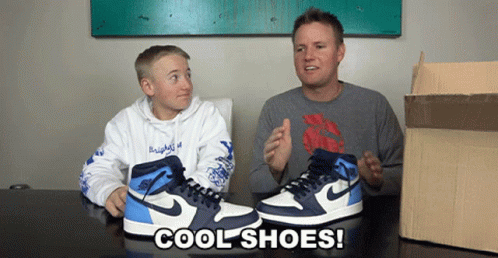 A Man And A Boy Sit At A Table With A Pair Of Cool Shoes GIF