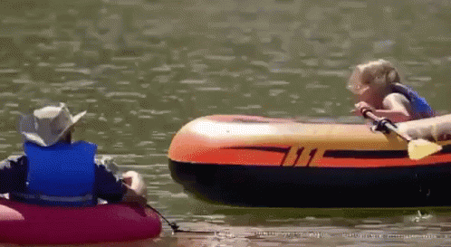 A Man And A Child Are In A Raft On A Lake GIF