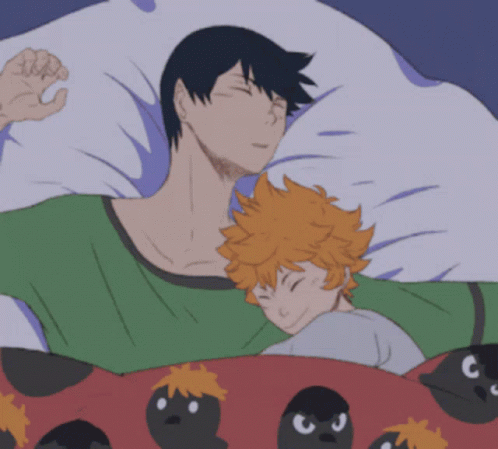 A Man And A Child Are Sleeping In A Bed With Birds On The Blanket GIF