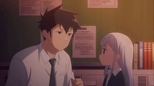 A Man And A Girl Are Looking At Each Other In Front Of A Wall With Papers Hanging On It GIF