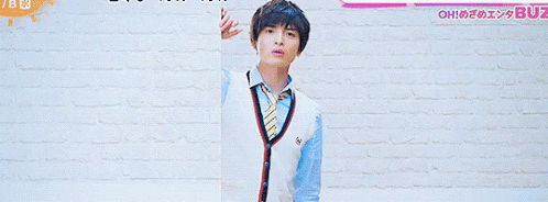 A Man And A Girl Are Standing In Front Of A Brick Wall With The Number 7 On The Bottom GIF