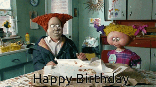 A Man And A Girl Sitting At A Table With The Words Happy Birthday Written On The Table GIF
