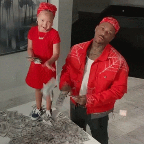 A Man And A Little Girl Are Standing Next To Each Other On A Pile Of Money . GIF