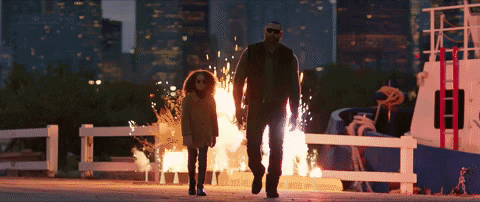 A Man And A Little Girl Are Walking In Front Of A Boat On Fire GIF